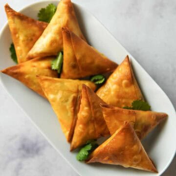 crispy chicken samosas served on a plate
