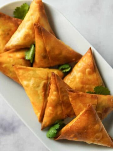 crispy chicken samosas served on a plate