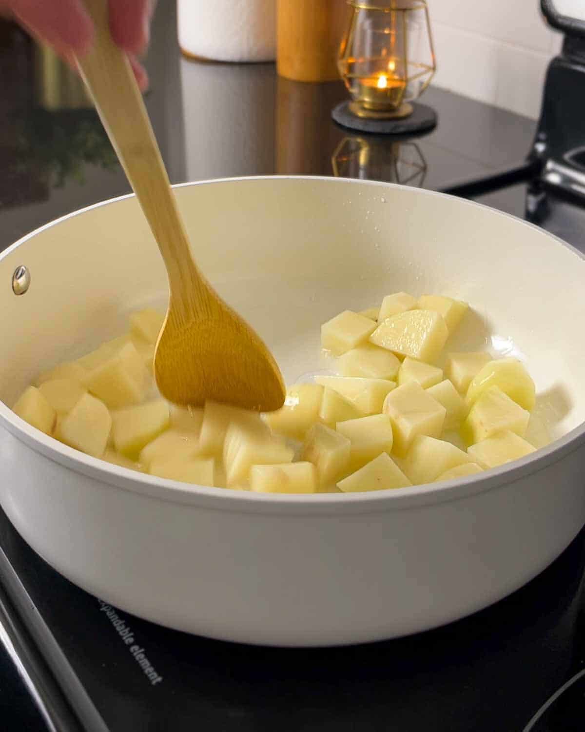 sautéing peeled potato cubes
