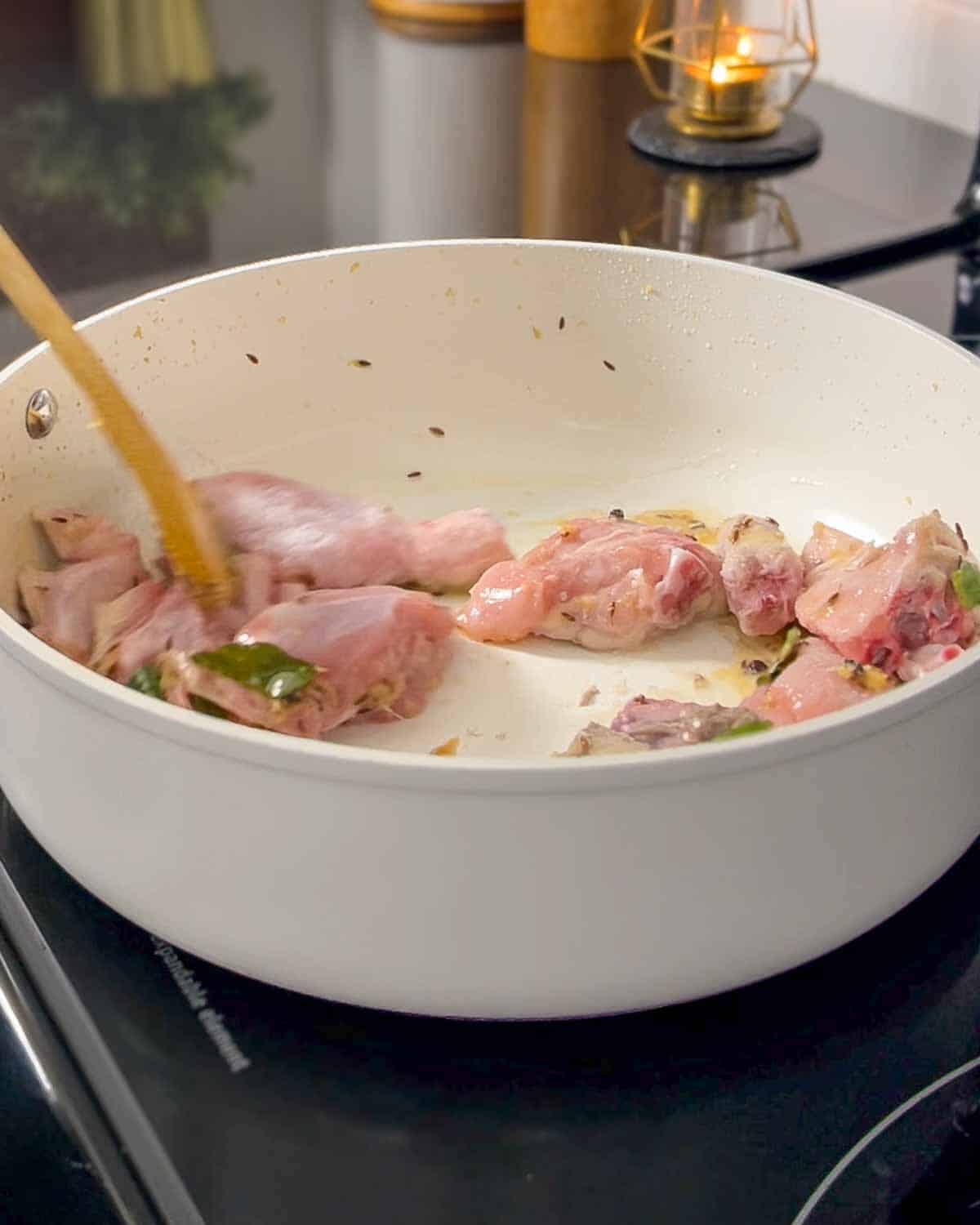 sautéing chicken with the spices and seasonings