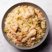 a plate containing delicious looking chicken matar pulao