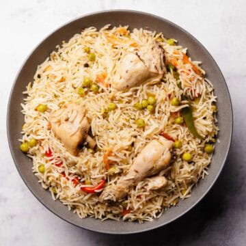 a plate containing delicious looking chicken matar pulao