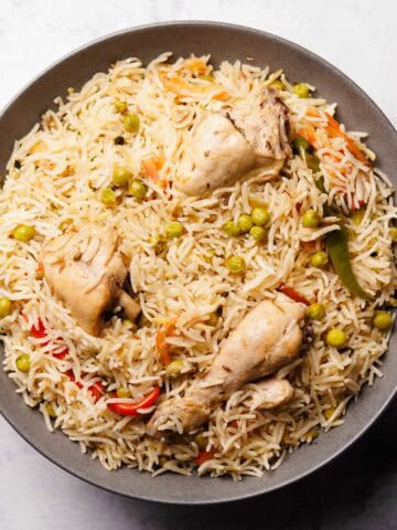 a plate containing delicious looking chicken matar pulao