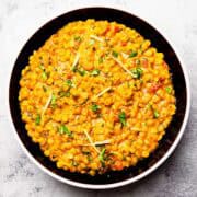 chana dal topped with julienned ginger, and cilantro served on a plate