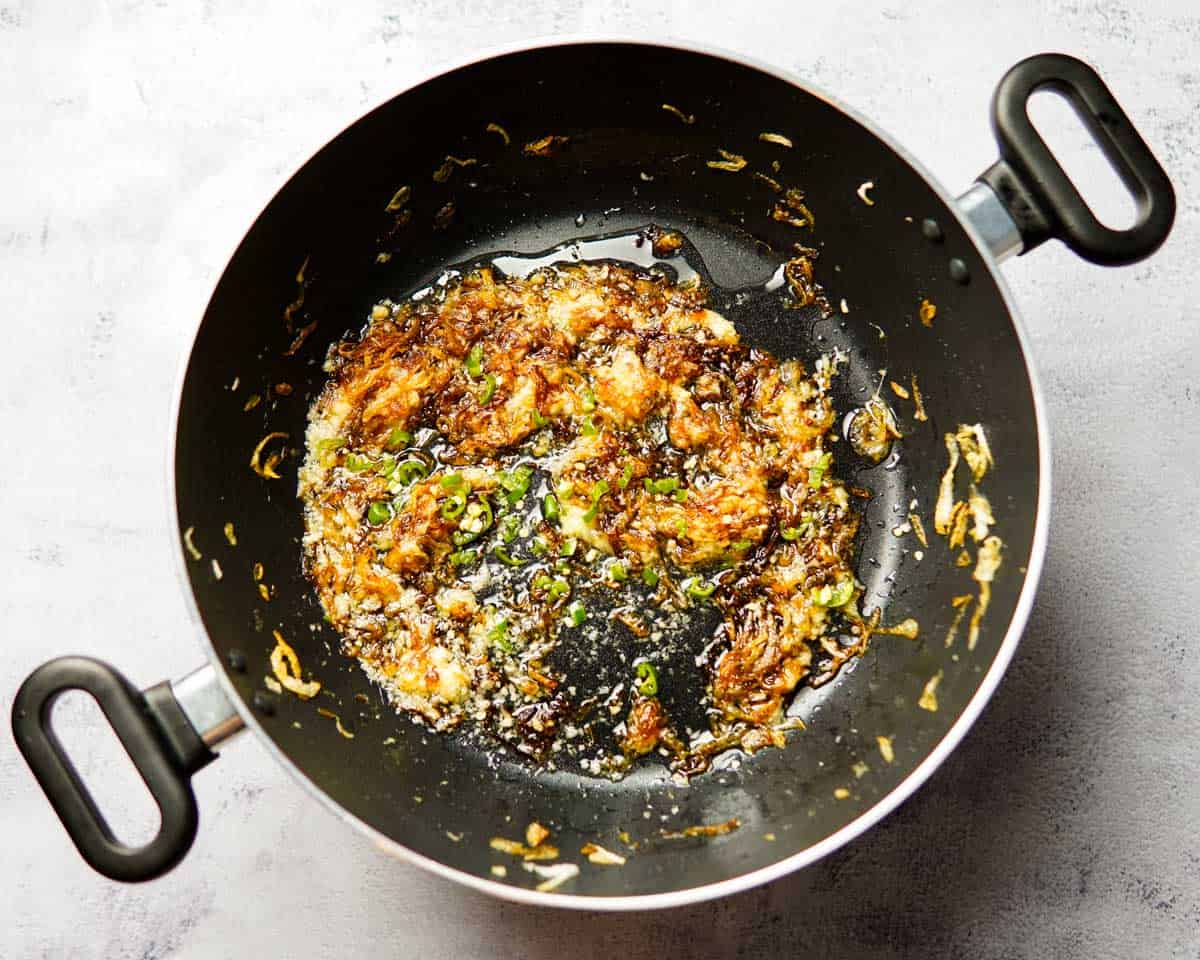 sautéed onion, ginger, garlic and green chilies in a pan