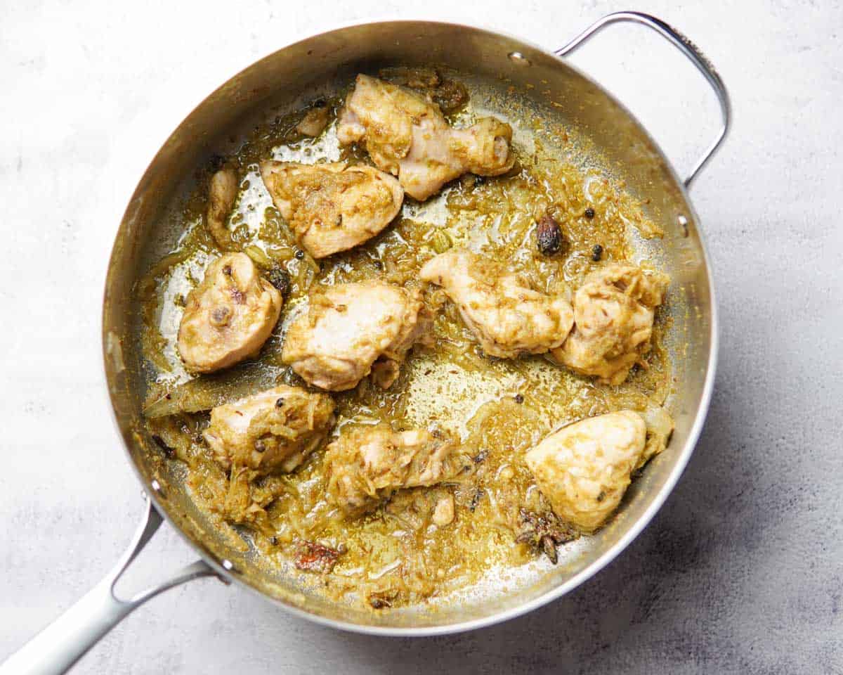 A pan with chicken cooked in spices