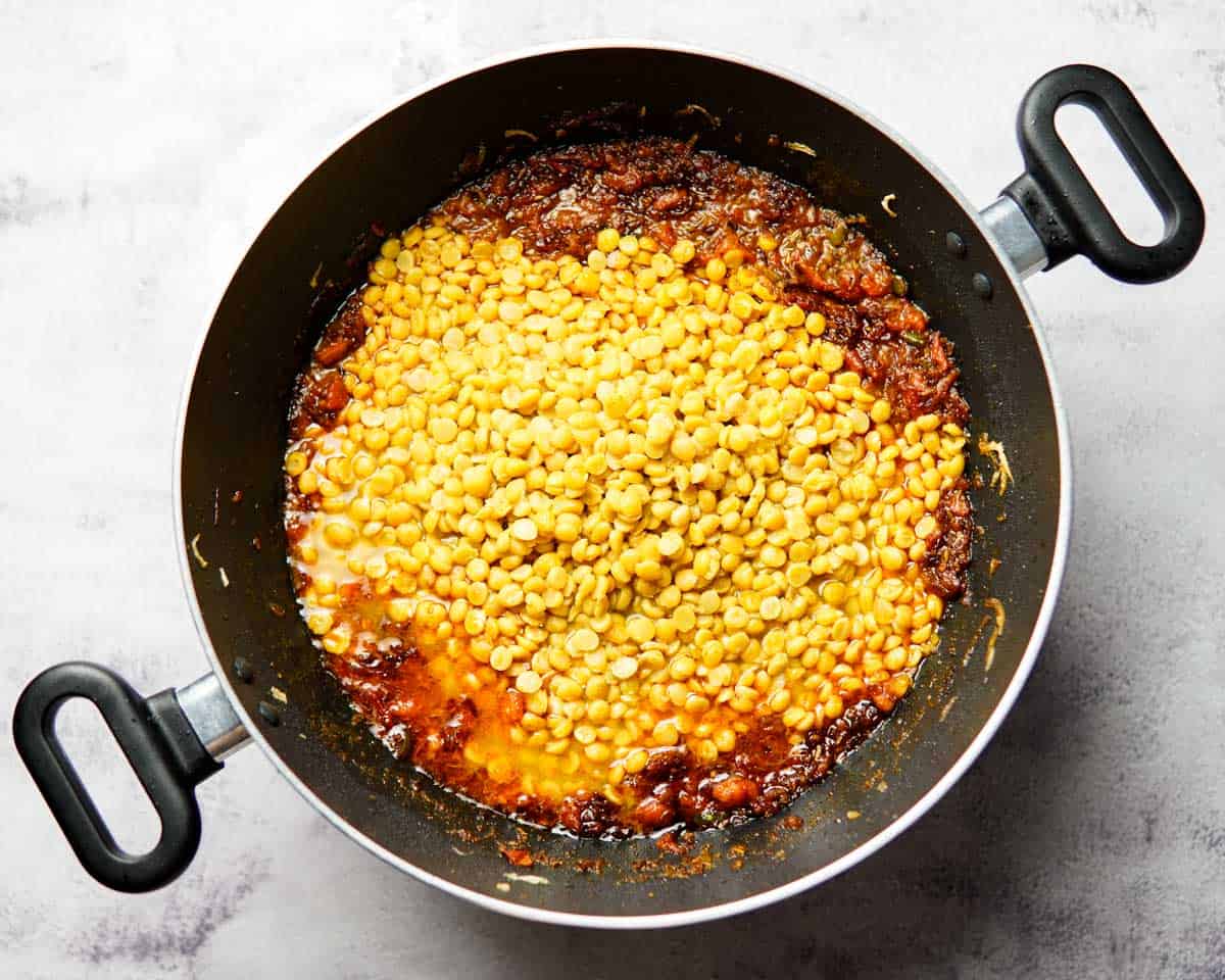 cooked chana dal and tomato base in a wide pan