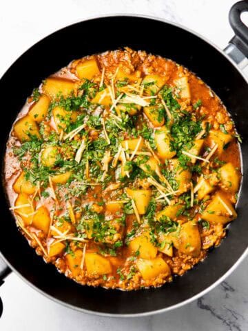 a wok containing chicken aloo keema
