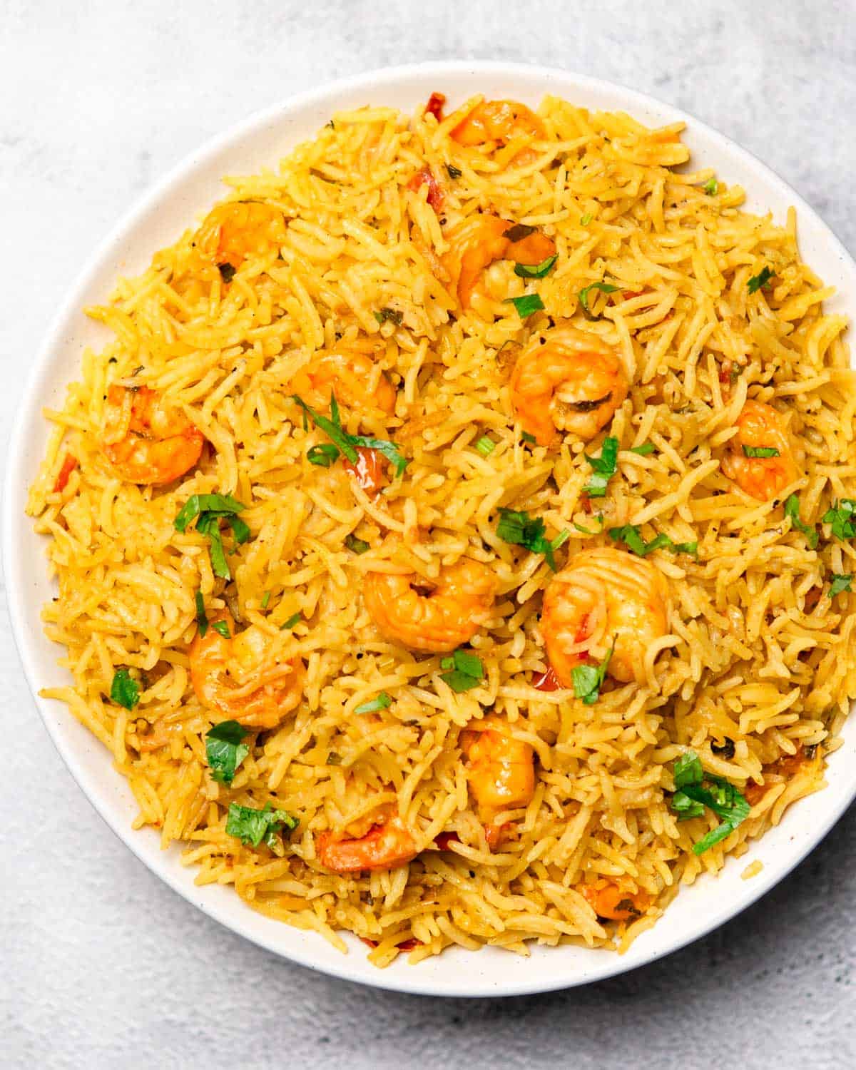 a plate containing jhinga pulao (aka shrimp/prawn pulao)
