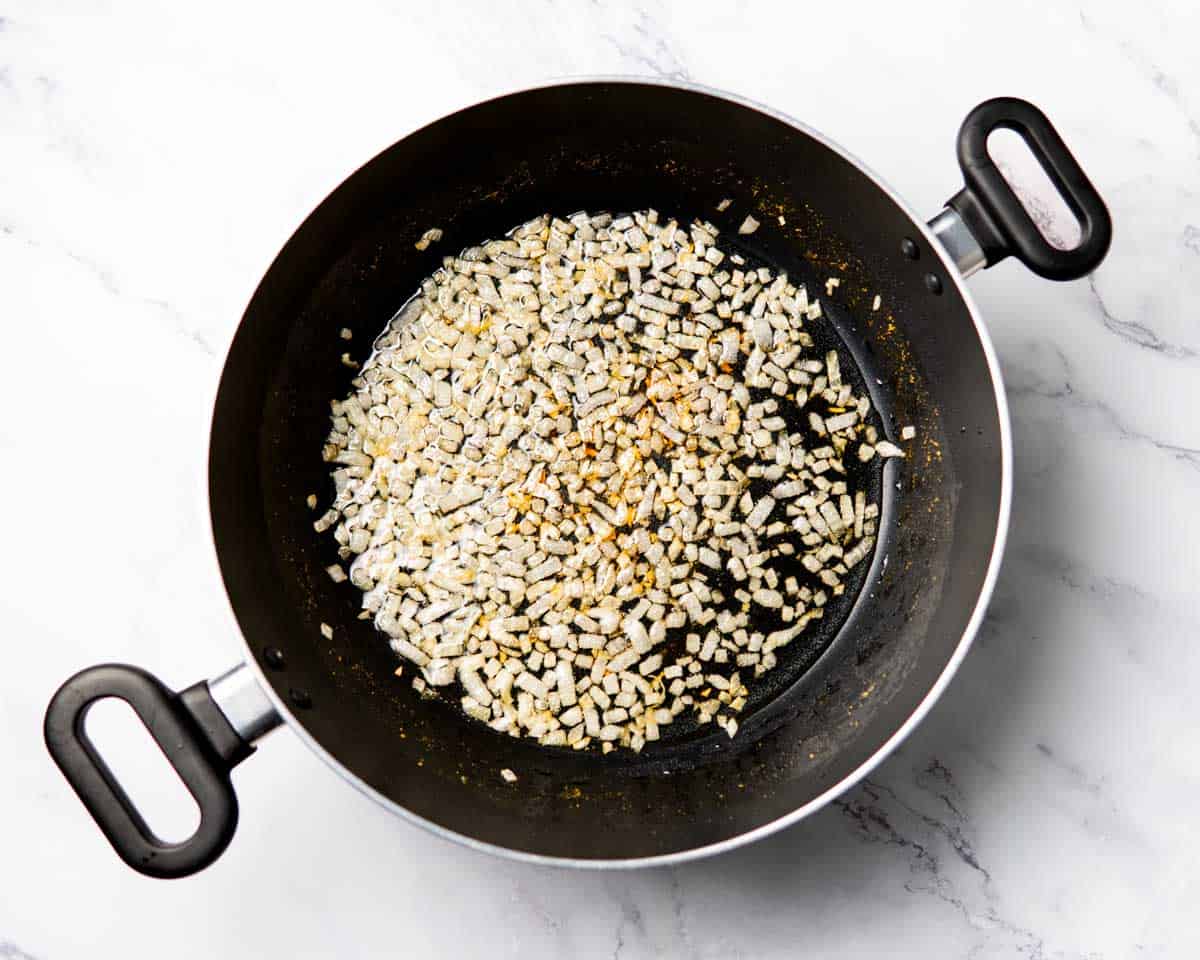 onion sautéing in a wok