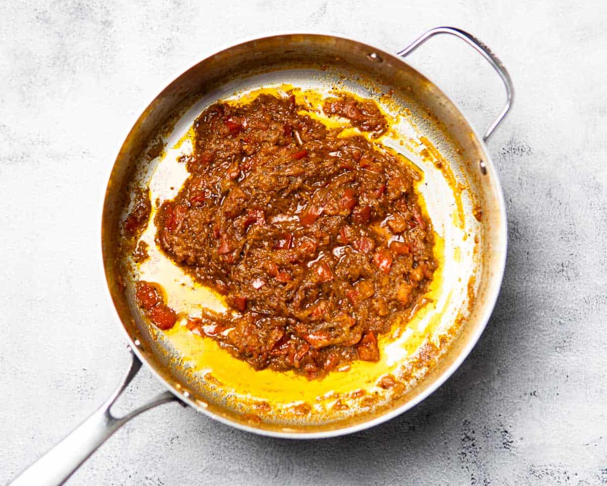 glossy tomato based sauce cooking in a pan