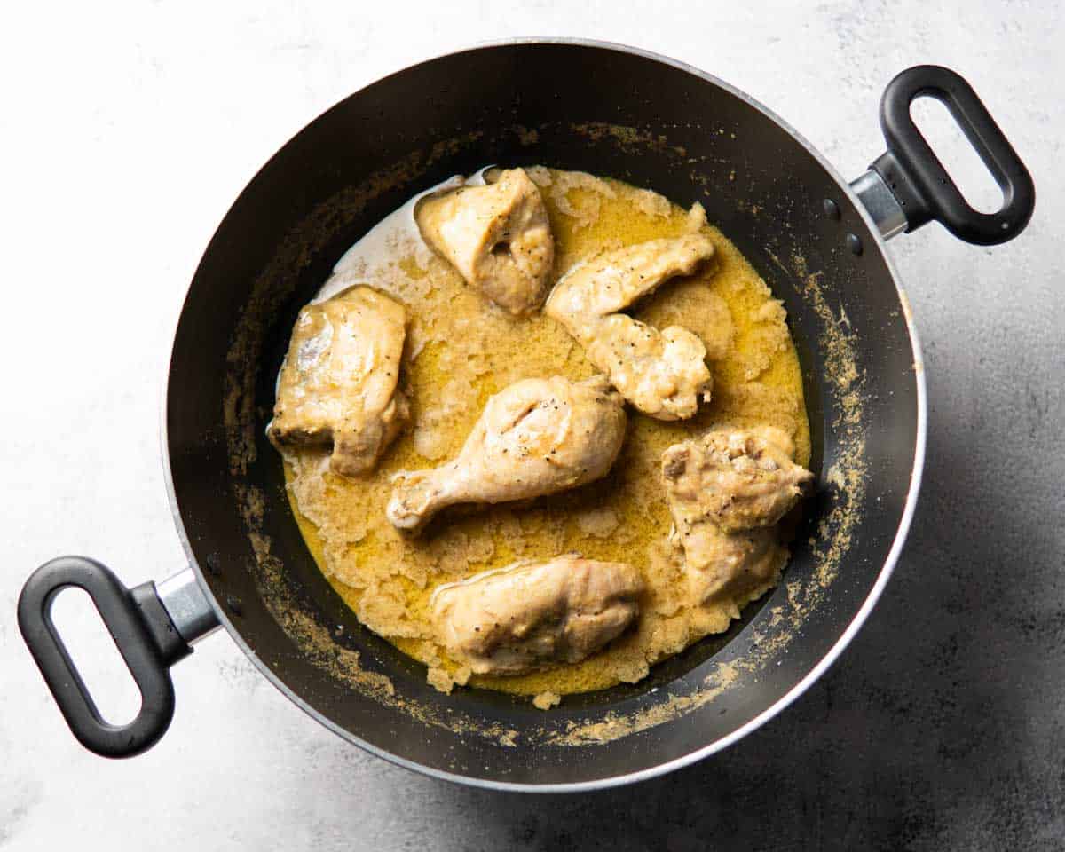 chicken, yogurt and spices cooking together in a karahi