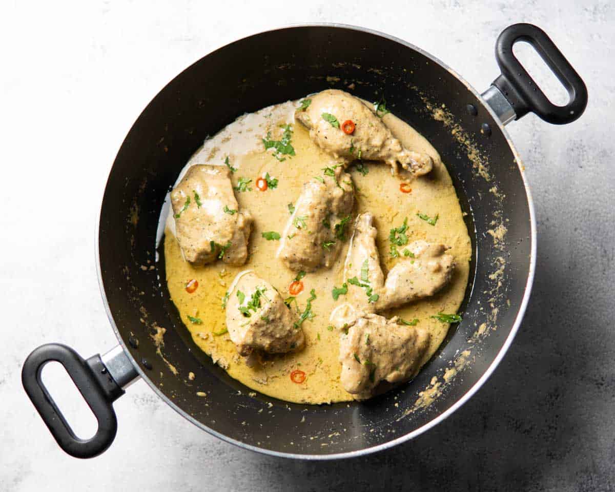 a wok containing cooked white chicken karahi