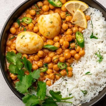 anda chana served with rice on a plate