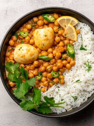 anda chana served with rice on a plate