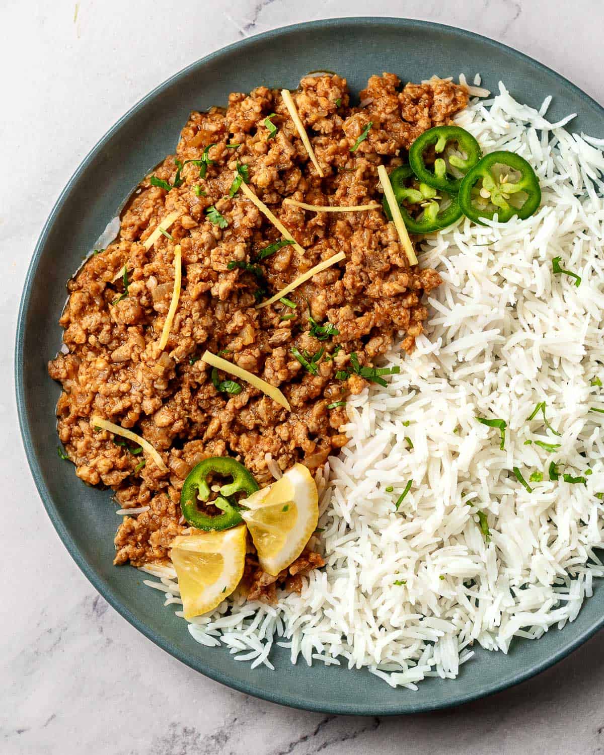 chicken keema served with rice on a plate